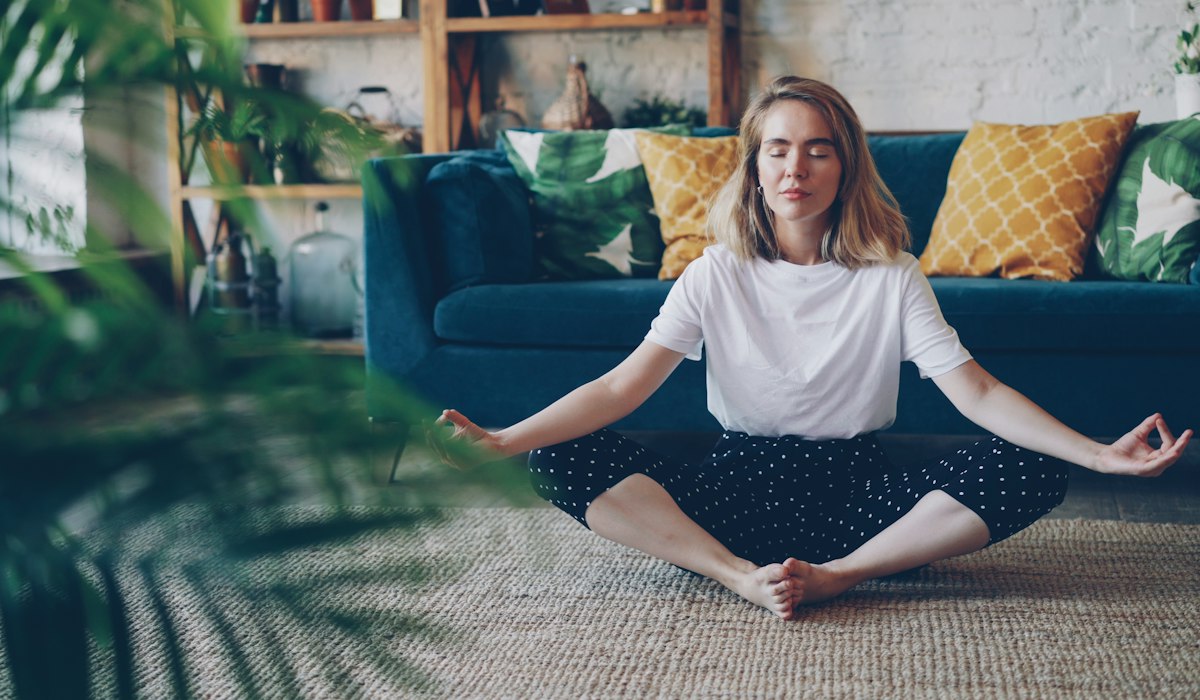 A woman meditating at home